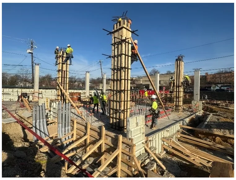Crawford Gardens — formed concrete columns under construction with bracing and crew access in place.