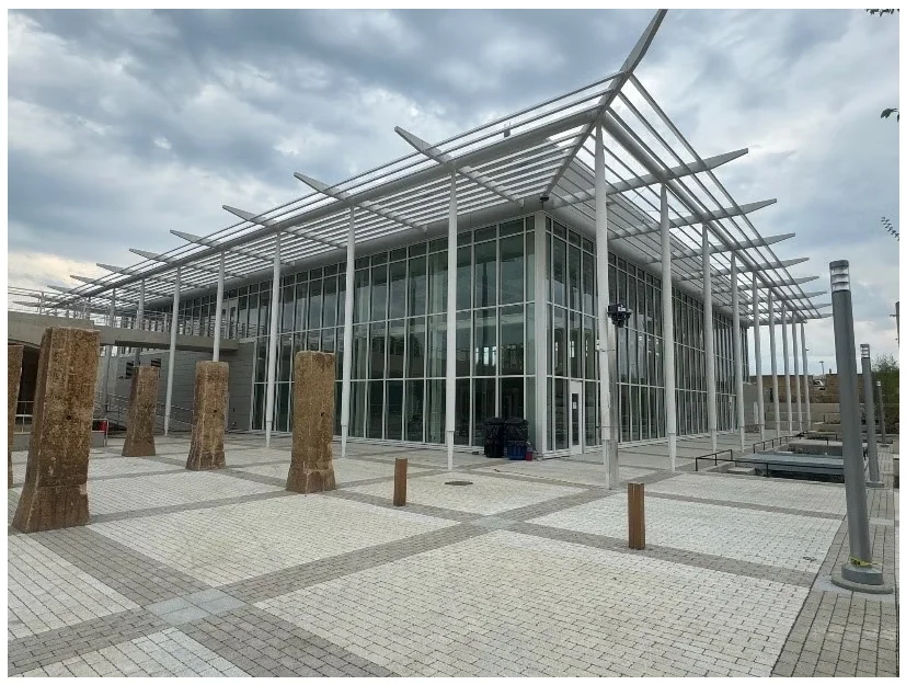 McMillan Community Center — exterior of the glass-enclosed community center building with steel canopy.