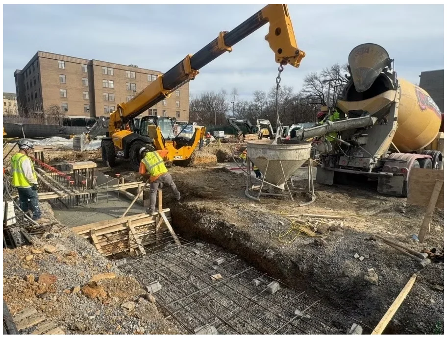Crawford Gardens — concrete foundation work with equipment and crew supporting a structural pour.